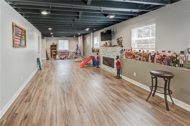 966 Moore Pl, Odessa, MO 64076 - playroom featuring a stone fireplace and wood finished floors