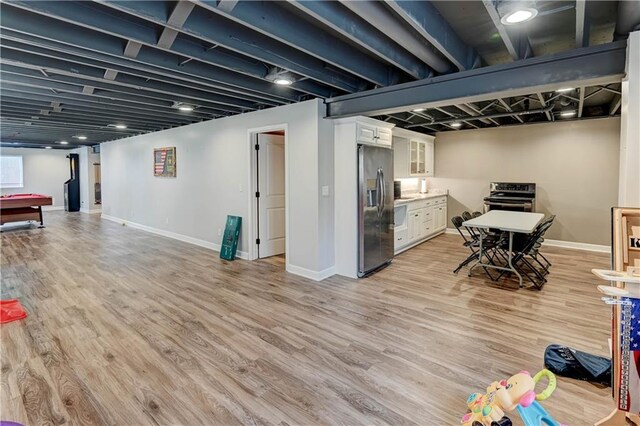966 Moore Pl, Odessa, MO 64076 - finished below grade area featuring stainless steel fridge with ice dispenser and light wood-type flooring
