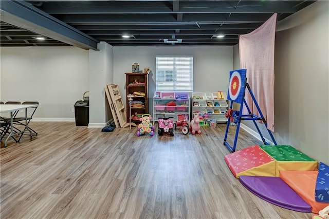 966 Moore Pl, Odessa, MO 64076 - rec room with wood finished floors and baseboards