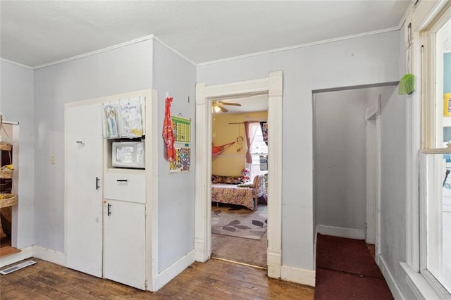 201 N Steuben Ave, Chanute, KS 66720 - entryway featuring wood finished floors, crown molding, and ceiling fan