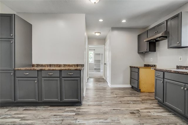 114 W 2nd St, Garden City, MO 64747 - kitchen with under cabinet range hood, gray cabinets, light wood-type flooring, baseboards, and recessed lighting