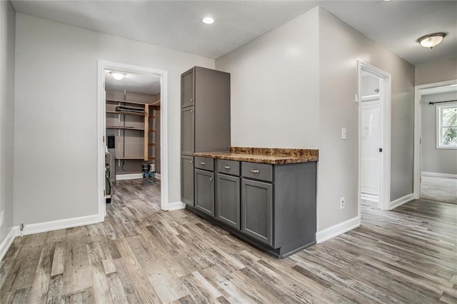114 W 2nd St, Garden City, MO 64747 - bar area featuring baseboards, light wood finished floors, and recessed lighting