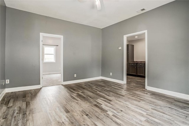 114 W 2nd St, Garden City, MO 64747 - unfurnished room with ceiling fan, wood finished floors, and baseboards
