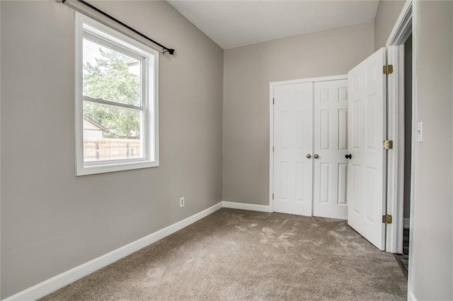 114 W 2nd St, Garden City, MO 64747 - unfurnished bedroom featuring carpet, baseboards, and a closet