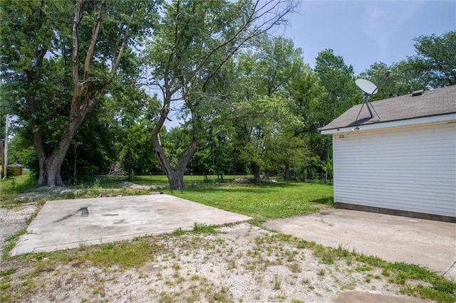 114 W 2nd St, Garden City, MO 64747 - view of grassy yard with a patio area and view of wooded area