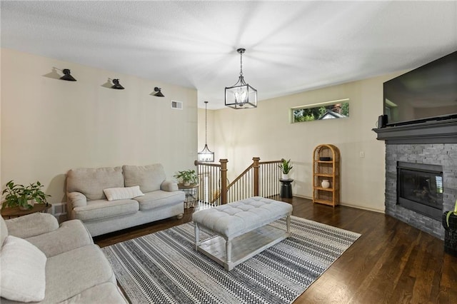 7907 W 59th Ter, Merriam, KS 66202 - living area with wood finished floors, a chandelier, and a fireplace