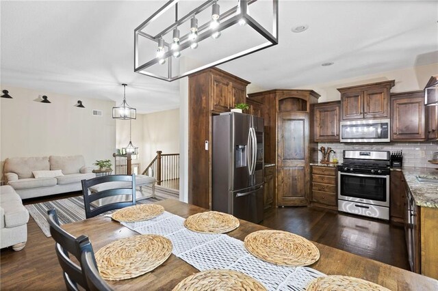 7907 W 59th Ter, Merriam, KS 66202 - kitchen with stainless steel appliances, a chandelier, and dark wood finished floors