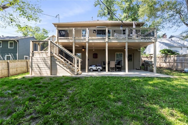 7907 W 59th Ter, Merriam, KS 66202 - back of property featuring ceiling fan, a fenced backyard, a patio area, stairway, and board and batten siding