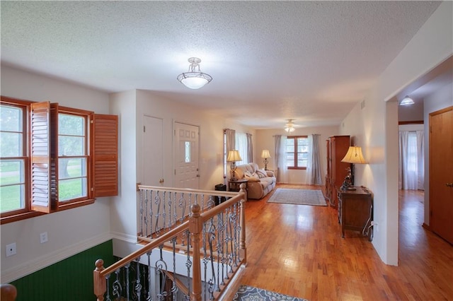 501 N Franklin St, Spring Hill, KS 66083 - hallway with an upstairs landing, light wood-style floors, and a textured ceiling