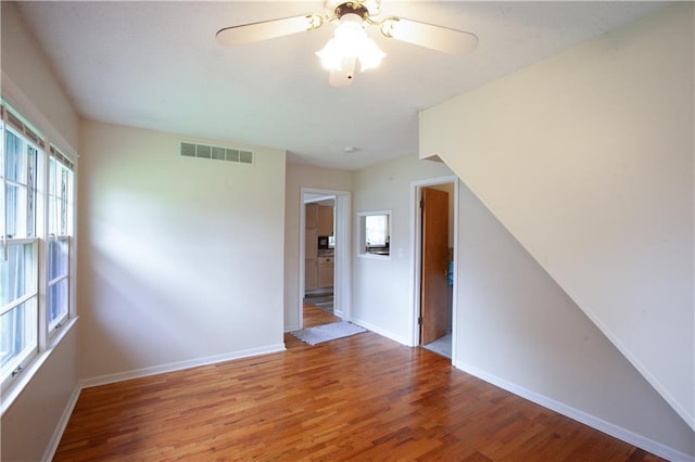 501 N Franklin St, Spring Hill, KS 66083 - empty room with wood finished floors and a ceiling fan