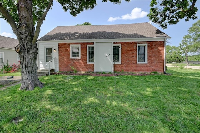 8 S Mulberry St, Louisburg, KS 66053 - view of front facade featuring brick siding, a front yard, entry steps, and a shingled roof