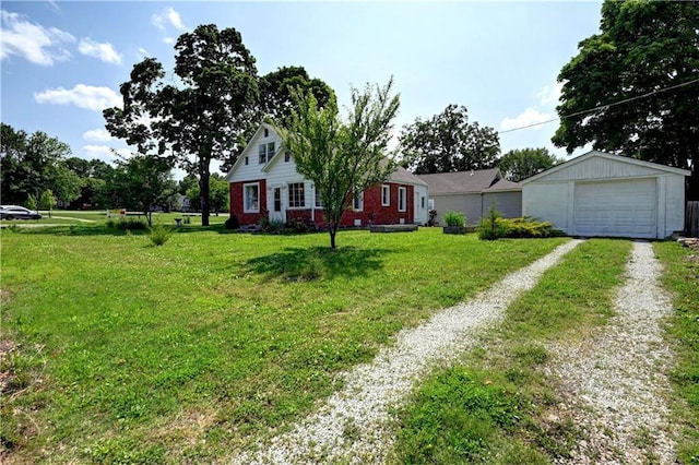 8 S Mulberry St, Louisburg, KS 66053 - view of front facade featuring driveway, a garage, an outbuilding, a front yard, and brick siding