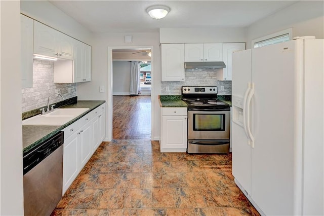 8 S Mulberry St, Louisburg, KS 66053 - kitchen featuring stainless steel appliances, a sink, under cabinet range hood, dark countertops, and tasteful backsplash