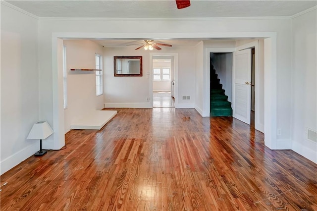 8 S Mulberry St, Louisburg, KS 66053 - empty room featuring baseboards, ceiling fan, wood finished floors, stairway, and ornamental molding