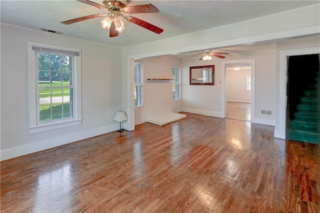 8 S Mulberry St, Louisburg, KS 66053 - unfurnished living room featuring a ceiling fan, wood finished floors, ornamental molding, baseboards, and a textured ceiling