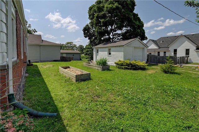 8 S Mulberry St, Louisburg, KS 66053 - view of yard featuring a vegetable garden, an outbuilding, and a garage