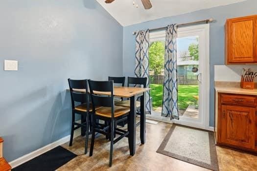 1203 S Skyline Dr, Liberty, MO 64068 - dining room featuring vaulted ceiling and ceiling fan