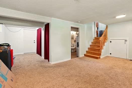 1203 S Skyline Dr, Liberty, MO 64068 - finished below grade area with carpet floors and stairway