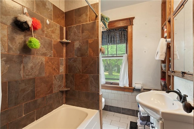 225 W Moore St, Independence, MO 64050 - full bath featuring tile walls, vanity,  shower combination, and tile patterned floors