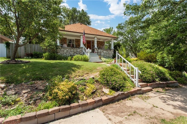225 W Moore St, Independence, MO 64050 - view of front of property with stone siding, a porch, and stairs