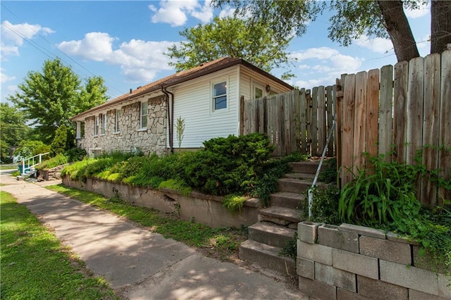 225 W Moore St, Independence, MO 64050 - view of side of home featuring stone siding