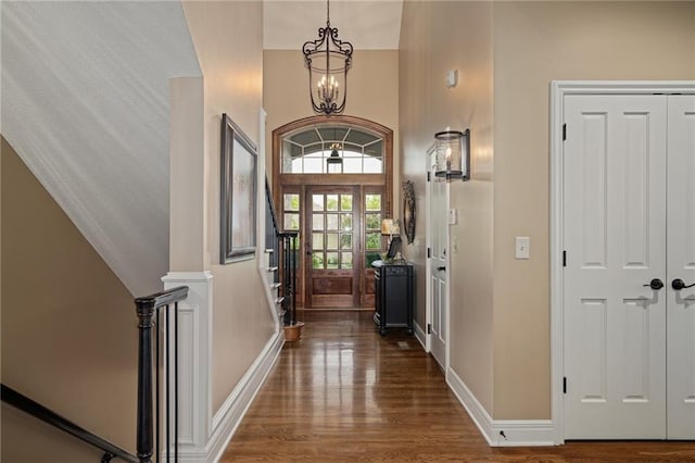 14208 Larsen St, Overland Park, KS 66221 - entryway with dark wood finished floors, a high ceiling, a chandelier, and stairs