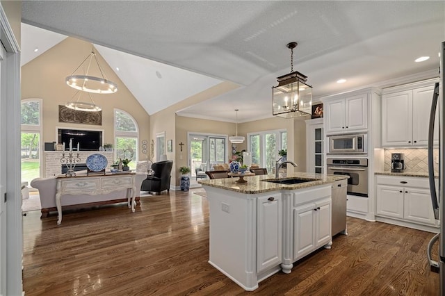 14208 Larsen St, Overland Park, KS 66221 - kitchen featuring stainless steel appliances, open floor plan, a chandelier, white cabinets, and recessed lighting