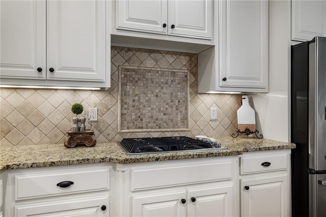 14208 Larsen St, Overland Park, KS 66221 - kitchen featuring stainless steel appliances, white cabinets, tasteful backsplash, and light stone countertops