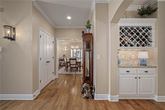 14208 Larsen St, Overland Park, KS 66221 - hallway with light wood-style flooring, ornamental molding, and recessed lighting