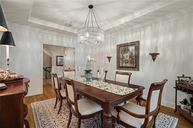 14208 Larsen St, Overland Park, KS 66221 - dining space featuring wood finished floors, a chandelier, and crown molding