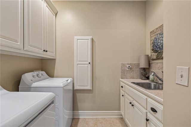 14208 Larsen St, Overland Park, KS 66221 - laundry area featuring washer and clothes dryer, cabinet space, and light tile patterned flooring