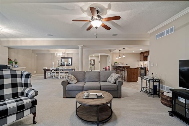 14208 Larsen St, Overland Park, KS 66221 - living area featuring light carpet, crown molding, ceiling fan, arched walkways, and a textured ceiling