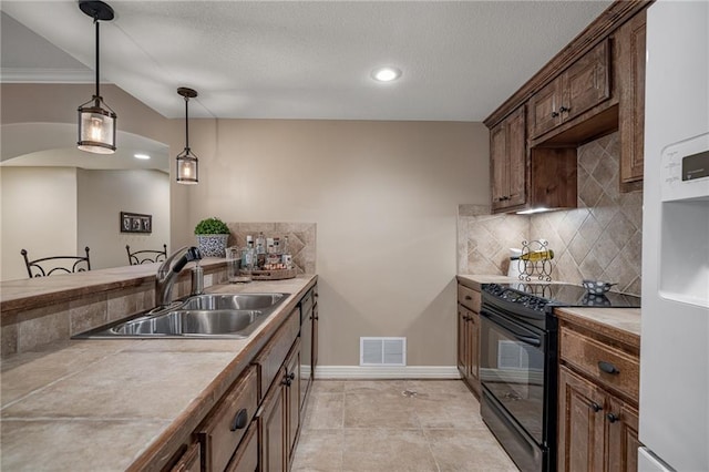 14208 Larsen St, Overland Park, KS 66221 - kitchen featuring electric range, backsplash, pendant lighting, light countertops, and arched walkways
