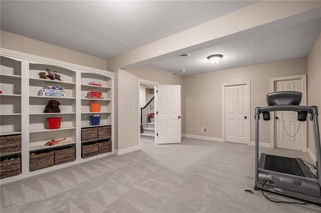 14208 Larsen St, Overland Park, KS 66221 - exercise area featuring light colored carpet and a textured ceiling