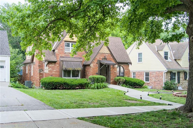 6645 Cherry St, Kansas City, MO 64131 - tudor-style house featuring a front yard and brick siding