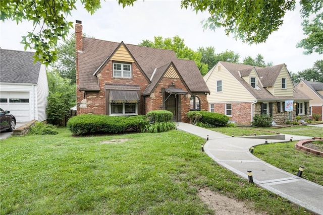 6645 Cherry St, Kansas City, MO 64131 - english style home with brick siding, a chimney, and a front yard