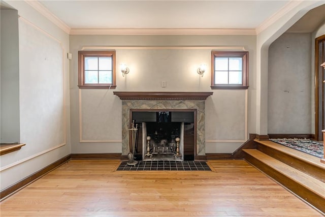 6645 Cherry St, Kansas City, MO 64131 - unfurnished living room featuring wood finished floors, healthy amount of natural light, a fireplace with flush hearth, and ornamental molding