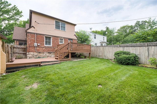6645 Cherry St, Kansas City, MO 64131 - back of property with a fenced backyard, a wooden deck, stairway, and brick siding