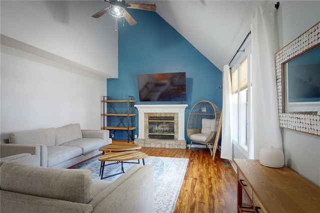 334 Fawn Valley Ct, Lansing, KS 66043 - living area featuring ceiling fan, wood finished floors, a glass covered fireplace, and high vaulted ceiling