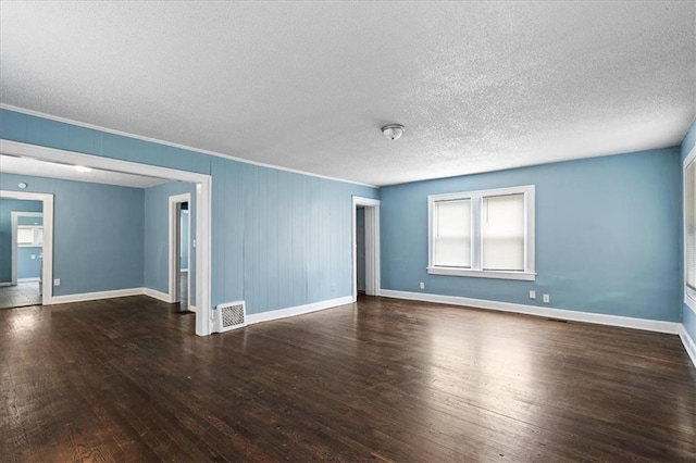 5701 Wabash Ave, Kansas City, MO 64130 - spare room with wood finished floors, baseboards, a textured ceiling, and ornamental molding