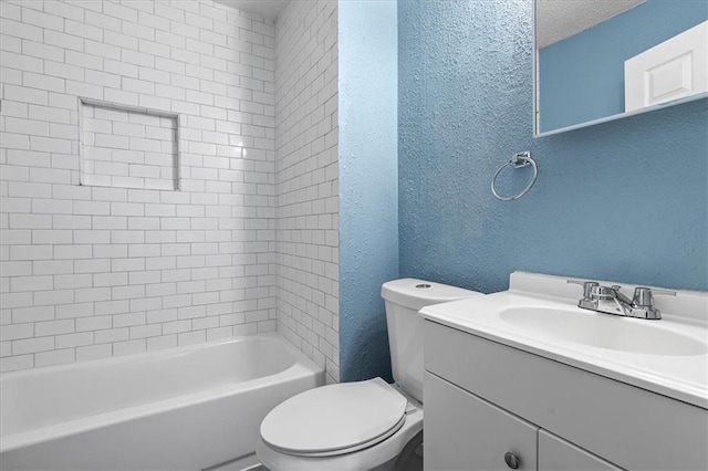 5701 Wabash Ave, Kansas City, MO 64130 - full bath featuring a textured wall, toilet, vanity, and shower / bath combination