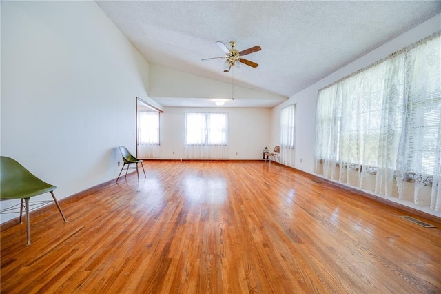 1110 E 1600th Rd, Lawrence, KS 66046 - empty room with lofted ceiling, wood finished floors, a ceiling fan, and a textured ceiling