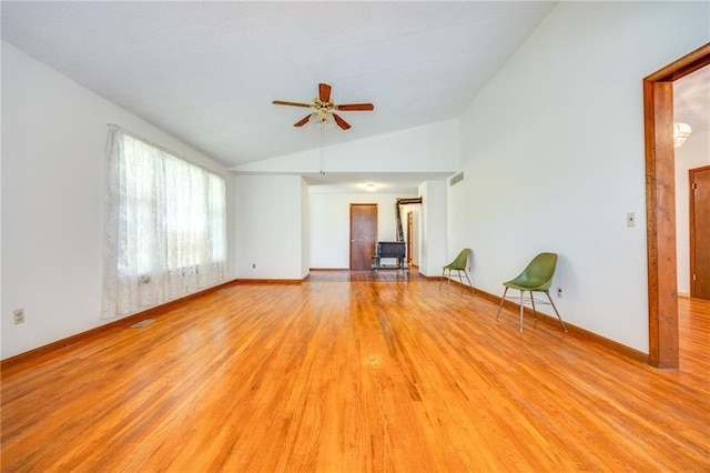 1110 E 1600th Rd, Lawrence, KS 66046 - empty room featuring lofted ceiling, a ceiling fan, light wood finished floors, and baseboards
