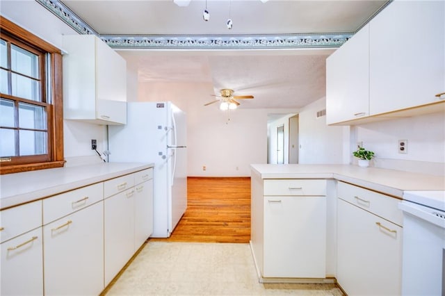 1110 E 1600th Rd, Lawrence, KS 66046 - kitchen featuring freestanding refrigerator, light countertops, white cabinets, a ceiling fan, and a peninsula