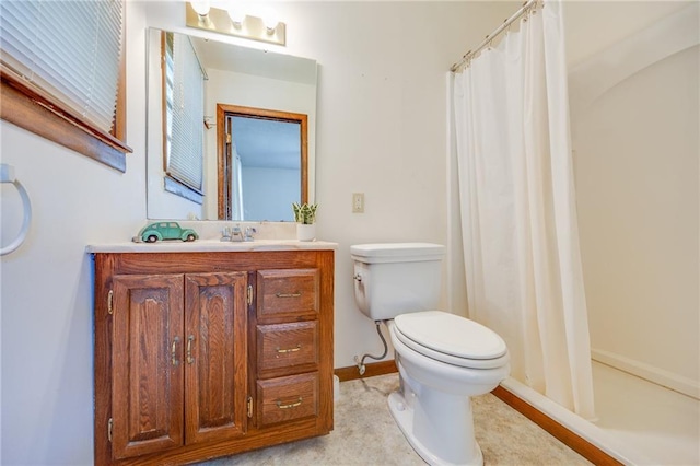 1110 E 1600th Rd, Lawrence, KS 66046 - bathroom with toilet, vanity, baseboards, and curtained shower