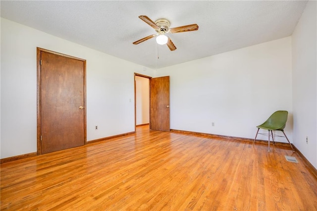 1110 E 1600th Rd, Lawrence, KS 66046 - empty room with light wood-style floors, a ceiling fan, and baseboards