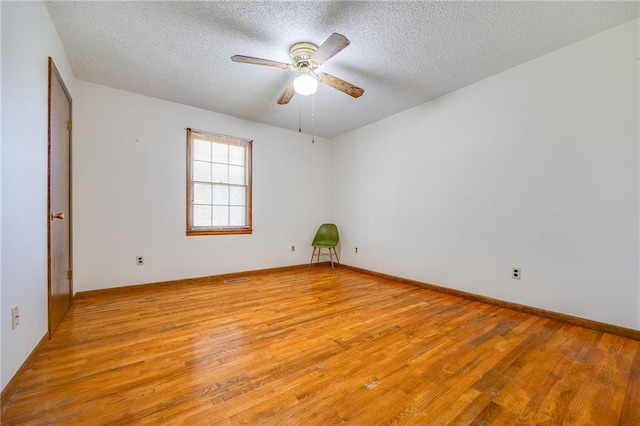 1110 E 1600th Rd, Lawrence, KS 66046 - spare room featuring light wood-type flooring, ceiling fan, and a textured ceiling