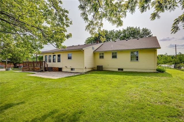 1110 E 1600th Rd, Lawrence, KS 66046 - back of property with a patio, a deck, a lawn, and central air condition unit