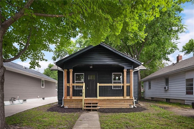 1220 E 24th Ave, Kansas City, MO 64116 - shotgun-style home featuring covered porch