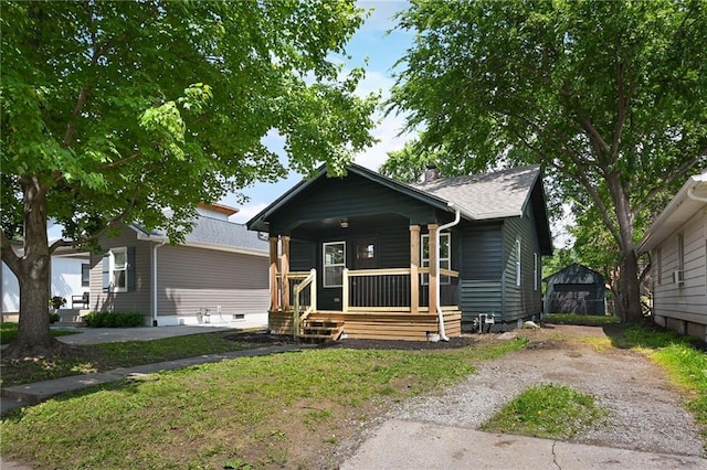 1220 E 24th Ave, Kansas City, MO 64116 - bungalow-style house with covered porch and dirt driveway